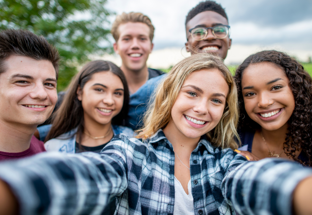group of teens taking selfie