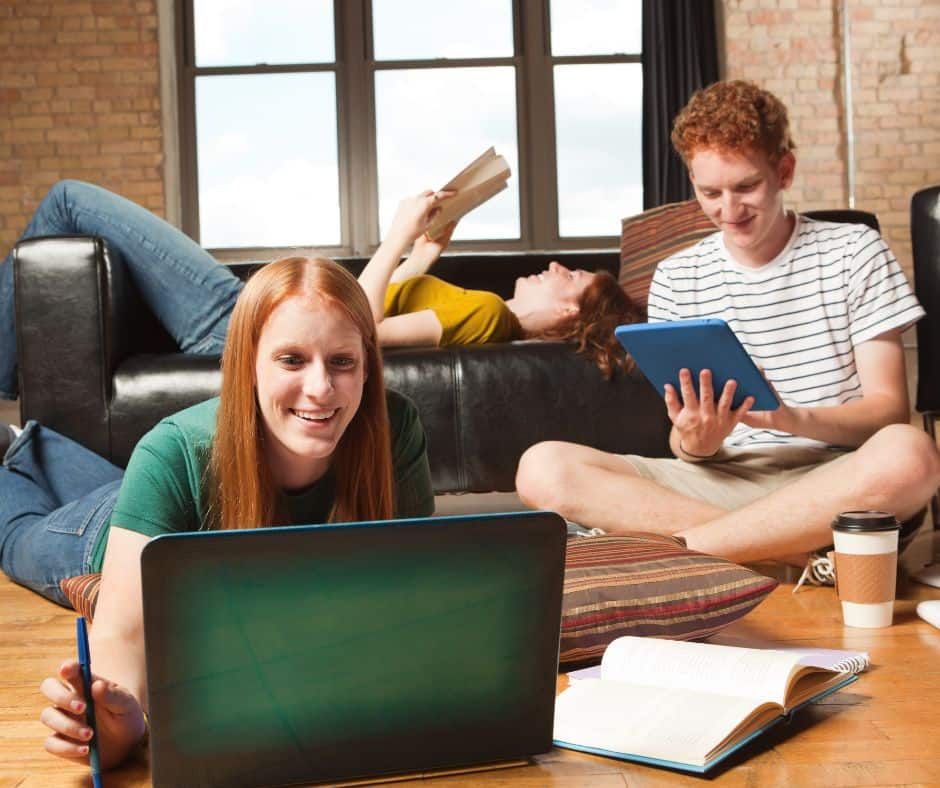 College Roommate Friends Working and Studying Together in Apartment