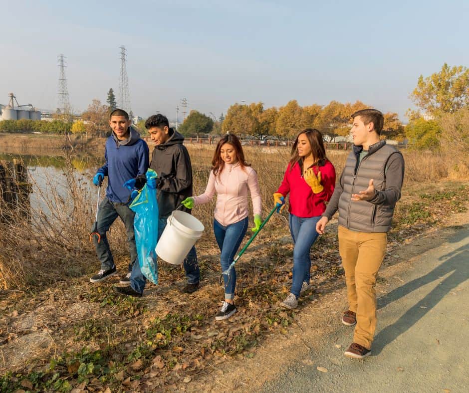 teens working on community service by cleaning up their neighborhood