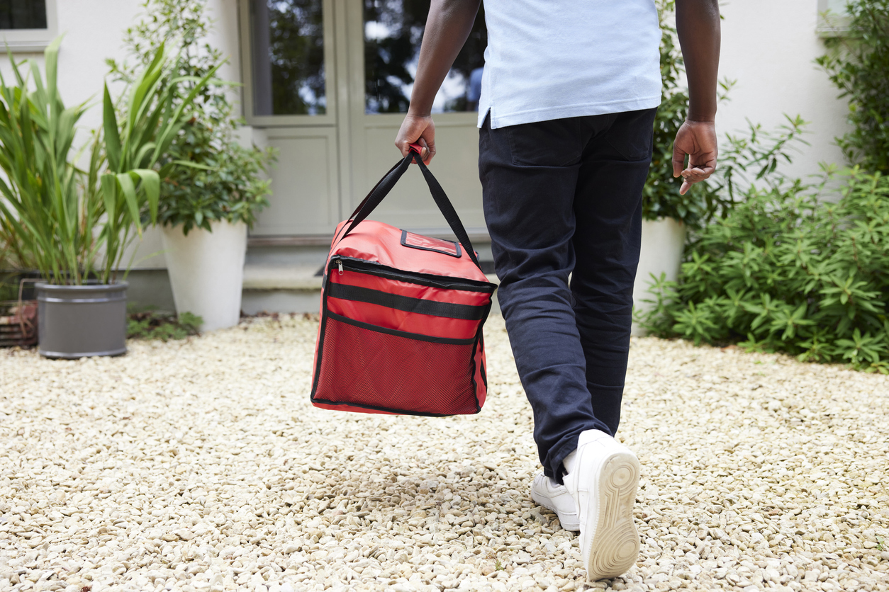 Close Up Rear View Of Gig Economy Driver Delivering Online Takeaway Food Order To House