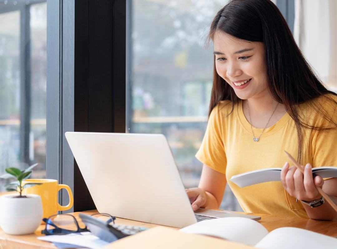 happy student on laptop