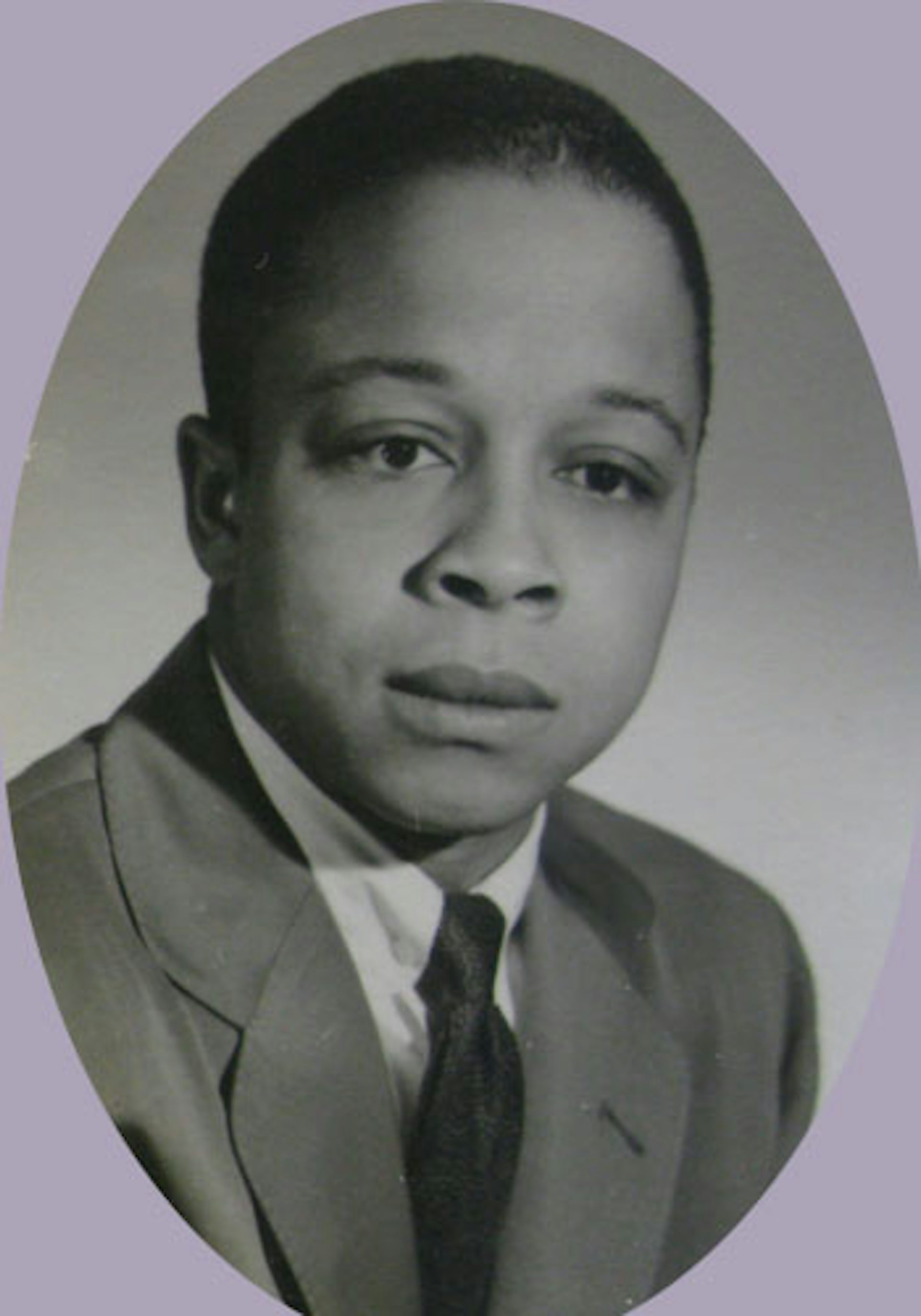 An oval black-and-white photo of a Black man wearing a suit and tie.