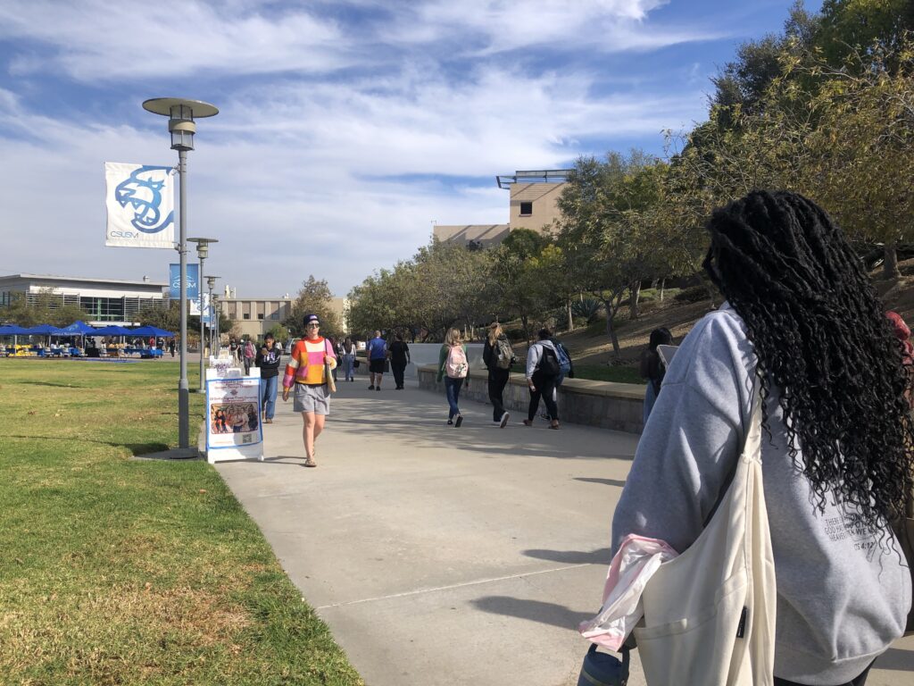 Students walk on a college campus.