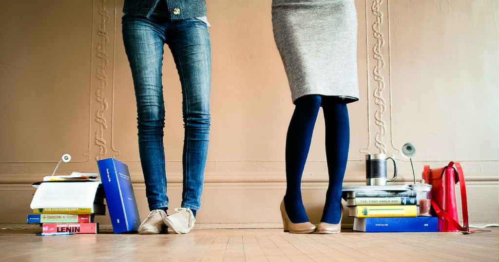 Two PhDs stand side by side. One has the materials they needed to get their PhD. The other has materials for their job after leaving academia or traditional professor career.