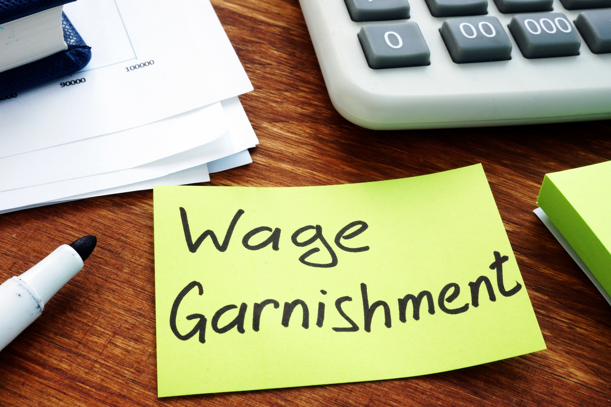 Wage Garnishment written on post-it